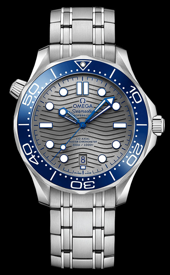 42mm – This watch has a stainless steel case with a blue ceramic rotating bezel with a diving scale crafted in white enamel. There is a grey ceramic dial under the domed sapphire crystal that features a modern update to the laser engraved wave pattern made iconic by the original Diver 300m in 1993. The skeleton hands and hour markers are rhodium plated and filled with Super-LumiNova. The date can be viewed at the 6 o’clock position.