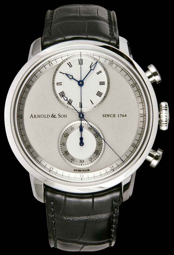 This timepiece has a stainless steel case with a domed sapphire crystal over the dial. The dial is a light grey with two sub dials that are a silvery-opaline color. The dial displays hours and minutes at the 12 o’clock subdial, central ‘True Beat’ seconds, and a 60 minute chronograph counter at the 6 o’clock position. The central seconds hand follows a 60 second track, in silver, around the inner bezel ring. It is incredibly difficult to create a ‘True Beat’ seconds in a mechanical watch.